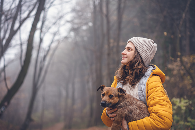 woman-with-dog-in-forest