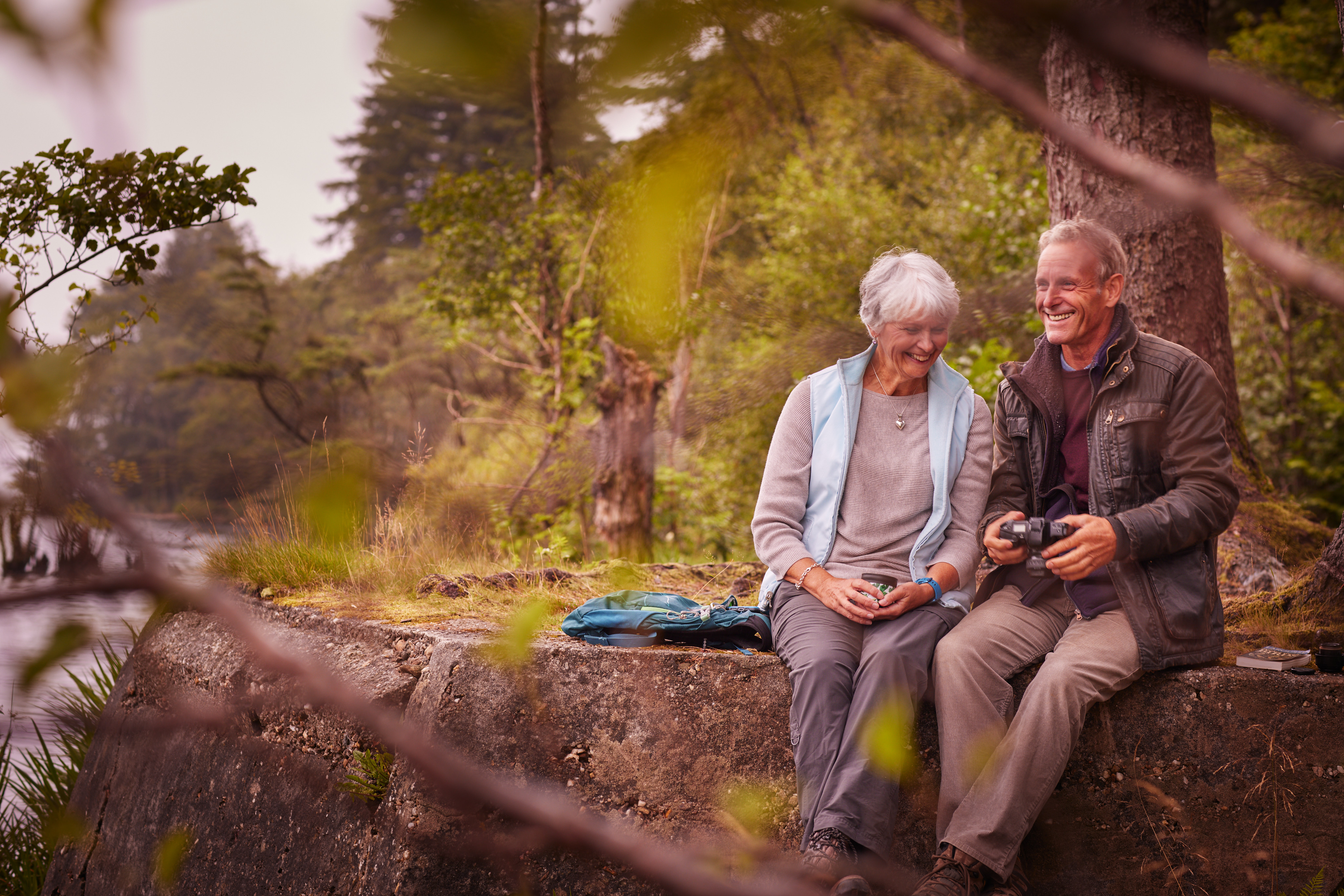 Older Couple sat in forest by Loch Eck
