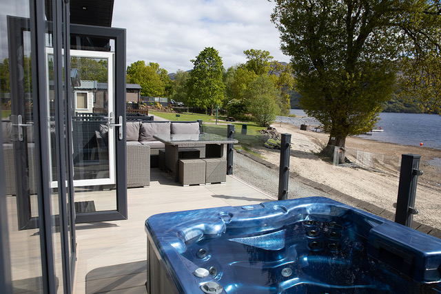 The outside area of waterside hot tub lodge!