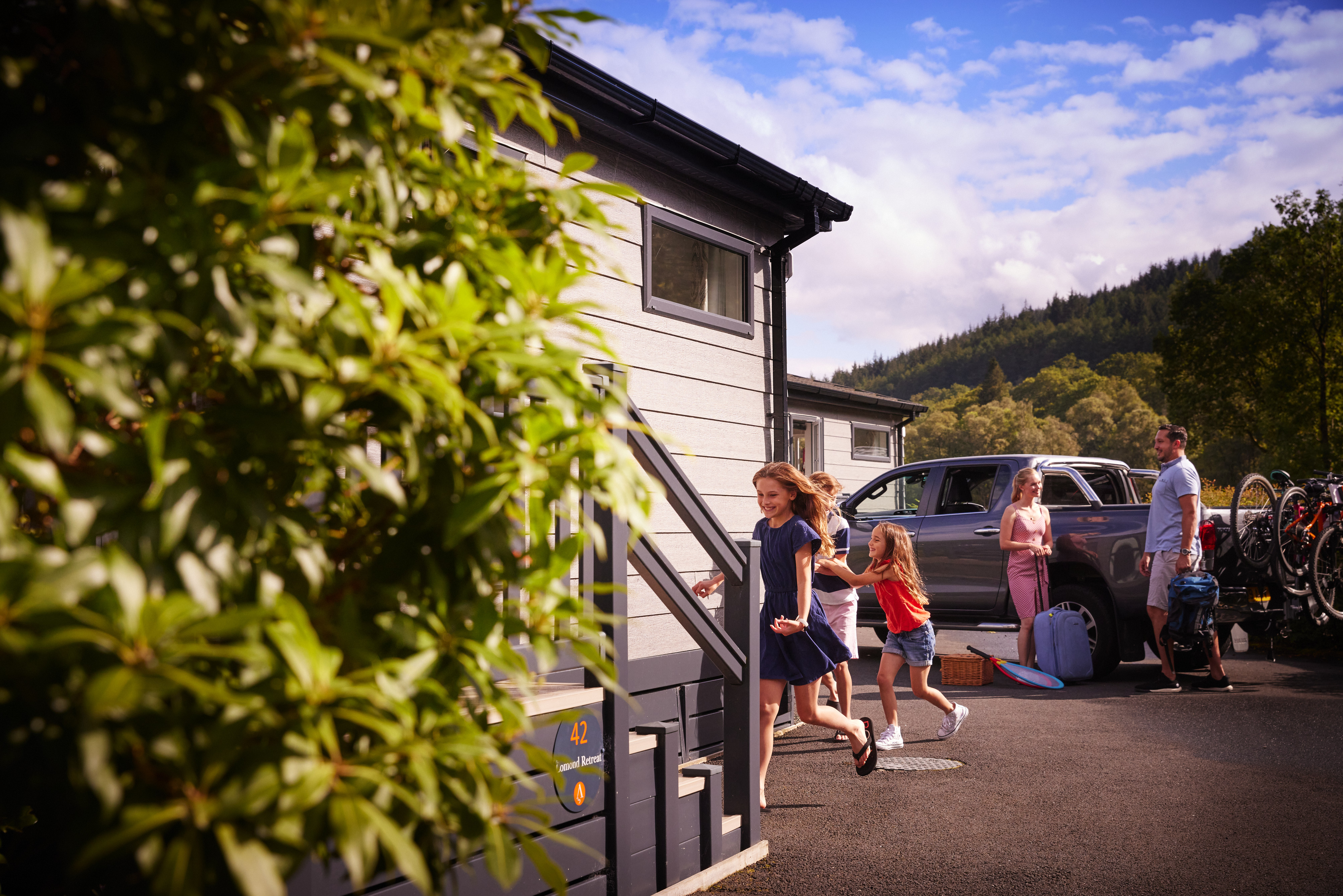 Family arriving at a Loch Lomond holiday lodge