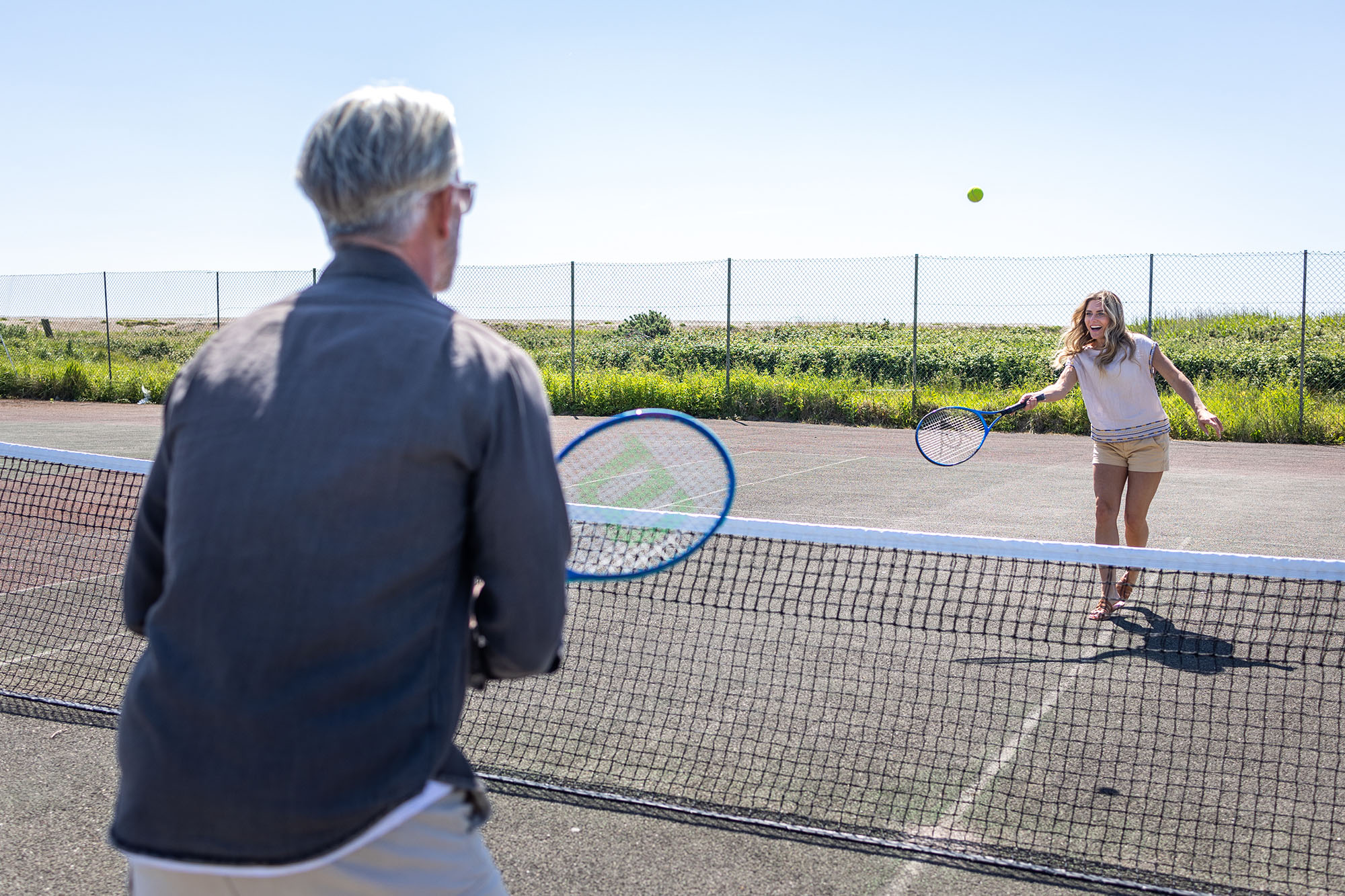 couple play a game of tennis at medmerry park